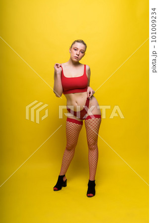 Young woman posing in underwear studio background. Perfect plump body, seductive lingerie. 101009234