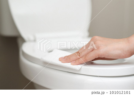 woman using tissue paper clean the toilet in the bathroom at home. 101012101