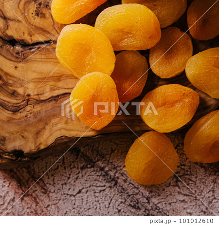 plastic container with dried apricots on wood plastic container with dried apricots on wood 101012610