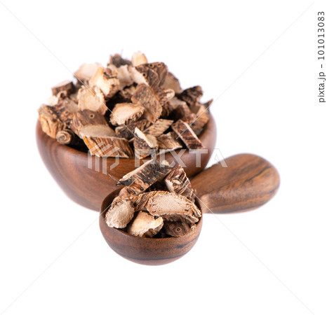 Calamus root in wooden bowl and spoon, isolated on white background. Sweet flag, sway or muskrat root. Dry root of Acorus calamus. Calamus root in wooden bowl and spoon, isolated on white background. Sweet flag, sway or muskrat root. Dry root of Acorus calamus. 101013083