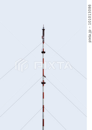 Telecommunication tower of cellular. Macro Base Station. radio network telecommunication equipment with radio modules and smart antennas mounted on a metal against sky background. Telecommunication tower of cellular. Macro Base Station. radio network telecommunication equipment with radio modules and smart antennas mounted on a metal against sky background. 101013086