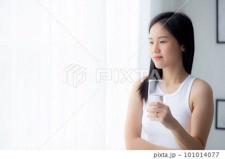 Beautiful young asian woman drinking glass of water mineral pure with fresh and happy. Beautiful young asian woman drinking glass of water mineral pure with fresh and happy. 101014077