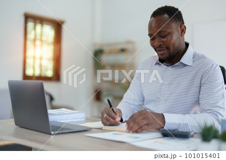 middle aged man American African using computer laptop with planning working on financial document, tax, exchange, accounting and Financial advisor. middle aged man American African using computer laptop with planning working on financial document, tax, exchange, accounting and Financial advisor. 101015401