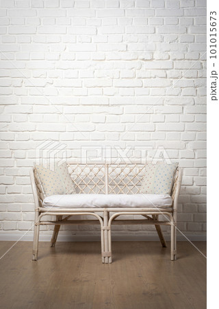 Rattan Living Room Loveseat on white brick wall background 101015673