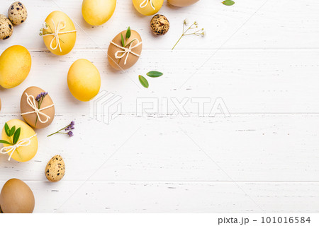 Easter eggs with flowers on a white table. Easter eggs with flowers on a white table. 101016584