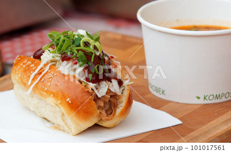A bun stuffed with pulled meat and vegetables at farmers market. A bun stuffed with pulled meat and vegetables at farmers market. 101017561