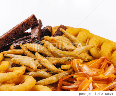 onion rings, fried smelt, pork ears on board 101018034