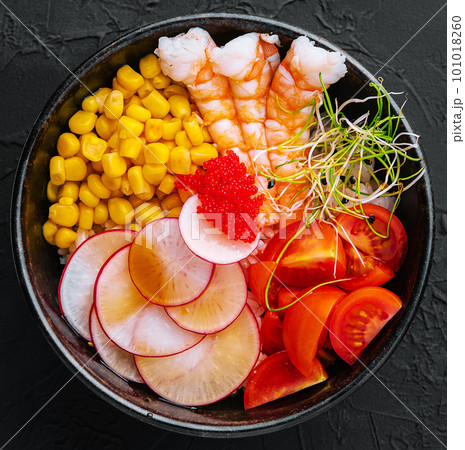 Bowls with tasty rice, shrimps and vegetables on dark background Bowls with tasty rice, shrimps and vegetables on dark background 101018260