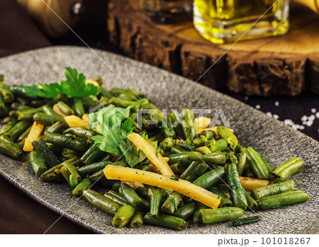 Fried wok green beans with onions and spices 101018267