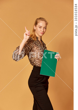 Portrait of one strict teacher wearing costume raising index finger up with serious face over orange background 101018584