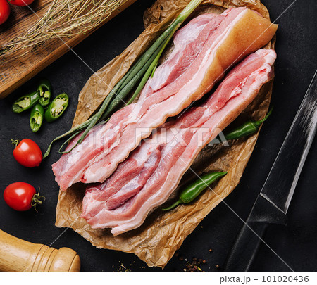 Delicious homemade raw-smoked, cured bacon top view Delicious homemade raw-smoked, cured bacon top view 101020436