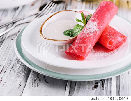 Rolled raspberry pancakes with sour cream for kids 101020449