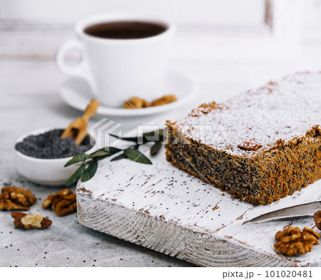 Juicy poppy seed cake with tea cup Juicy poppy seed cake with tea cup 101020481