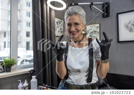 Gray-haired tatoo master looking excited and enjoyed 101022723
