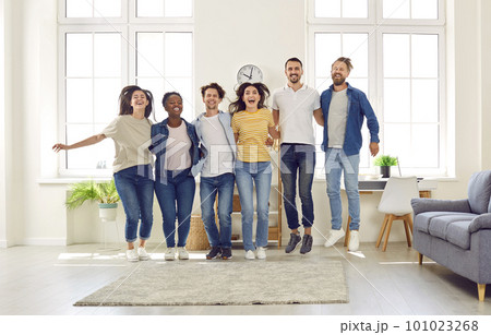 Group of cheerful multiracial friends hugging each other and jumping all together Group of cheerful multiracial friends hugging each other and jumping all together 101023268