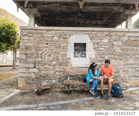 Asturias historical building Villanueva heritage. Mixed race couple together outdoor with tablet 101023317