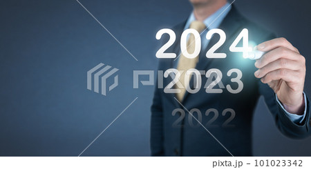 Businessman writing 2024 year on virtual screen. Business and Technology goals and achievement in 2024. economic forecasts for 2024. businessman writes 2024 on virtual screen Businessman writing 2024 year on virtual screen. Business and Technology goals and achievement in 2024. economic forecasts for 2024. businessman writes 2024 on virtual screen 101023342