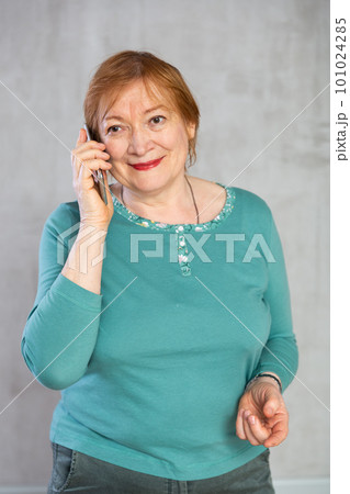 Senior woman taking phone call confidently with smile full of cheer 101024285