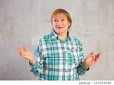 Older woman standing proudly with happy confident grin 101024286