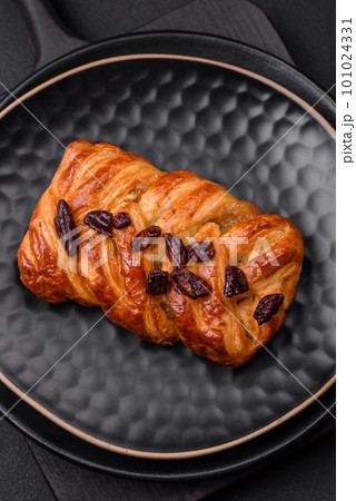 Delicious fresh baked pigtail bun with nuts and syrup Delicious fresh baked pigtail bun with nuts and syrup 101024331