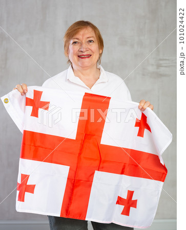 Cheerful senior woman standing confidently with georgian flag 101024422