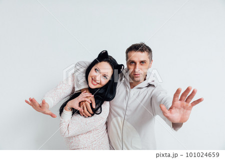 a man with a hand forward hugs a woman husband and wife 101024659
