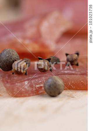 Spices of cloves on a piece of meat 101025736