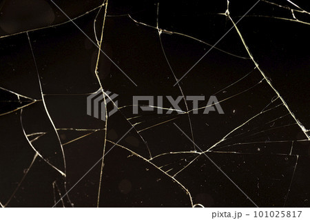 glass broken into a large number of pieces and cracks 101025817