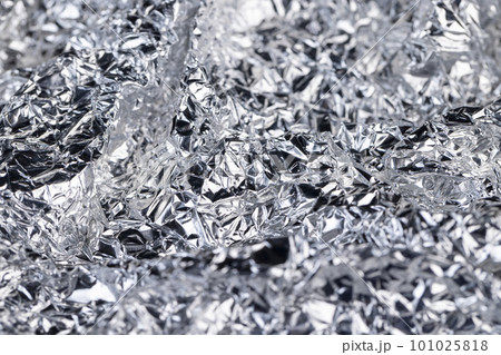 crumpled thin aluminum foil reflecting light 101025818