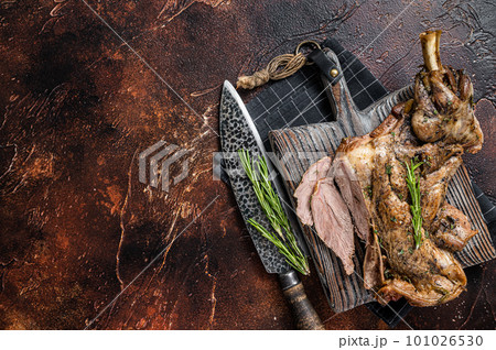 Slow Cooked grilled lamb mutton shoulder meat with herbs and spices on wooden board. Dark background. Top view. Copy space Slow Cooked grilled lamb mutton shoulder meat with herbs and spices on wooden board. Dark background. Top view. Copy space 101026530