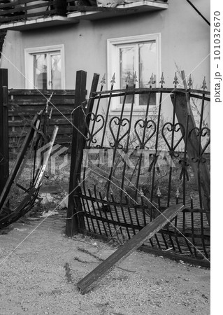 Destroyed building after russian invasion, Ukraine. Ruined facade of house, black and white. War in Ukraine. Broken windows and brick walls after missile attack. Abandoned burnt home. War disaster. 101032670