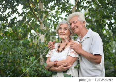 elderly couple walks in nature in summer elderly couple walks in nature in summer 101034797