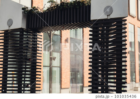 Water spray system for cooling in public place street at the boiling hot summer day. Water mist sprays from arch to alleviate summer heat. Air cooling system with water vapor. Heat global warming  101035436
