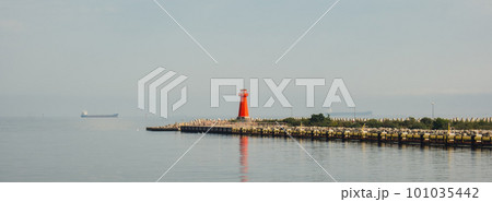 Lighthouse on blue sea line. Waves on sunny day on Baltic sea. Gdansk Poland. Swimming by ship to lighthouse 101035442