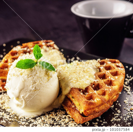 Ice cream with belgian waffles, fresh mint, vanila topping Ice cream with belgian waffles, fresh mint, vanila topping 101037584