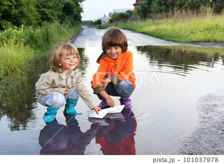 three boy play in puddle three boy play in puddle 101037978