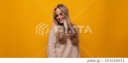 european girl smiling on yellow background 101038051