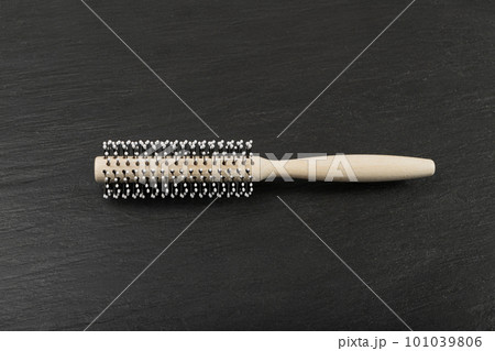 Wood Round Hairbrush on Black Stone Texture Background, Natural Wooden Massage Hair Brush Wood Round Hairbrush on Black Stone Texture Background, Natural Wooden Massage Hair Brush 101039806