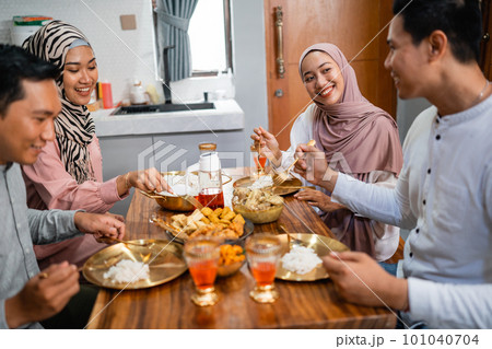 friends having iftar dinner together at home 101040704