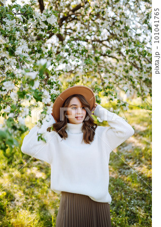 Beautiful young woman near blooming spring tree. Youth, love, fashion, romantic, lifestyle concept. Beautiful young woman near blooming spring tree. Youth, love, fashion, romantic, lifestyle concept. 101041765