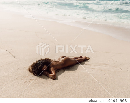 Naked girl sunbathe on beach. Sexy latin model with perfect body enjoying at tropical beach Naked girl sunbathe on beach. Sexy latin model with perfect body enjoying at tropical beach 101044968