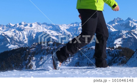 Unknown hiker walking against beautiful snowy Swiss Alps background Unknown hiker walking against beautiful snowy Swiss Alps background 101046148
