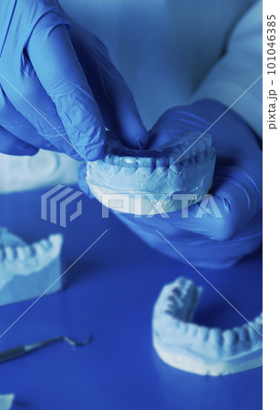 technician tests an occlusal splint technician tests an occlusal splint 101046385