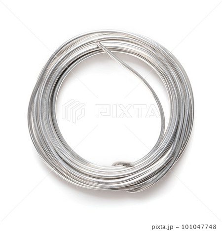 Rolled up soft solder wire. Fusible metal alloy with 60 percent tin, used to create a permanent bond between metal workpieces and for electrical connections. Close up, from above, on white background. Rolled up soft solder wire. Fusible metal alloy with 60 percent tin, used to create a permanent bond between metal workpieces and for electrical connections. Close up, from above, on white background. 101047748