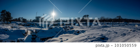 Sioux Falls Park during winter with frozen waterfall and snow cover. 101050559