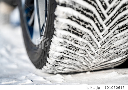 Closeup selective focus on snow packed in an all-weather tire tread. 101050615