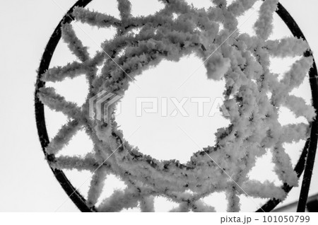 Early morning frost on the netting of a basketball hoop in the winter 101050799