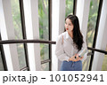 Young Asian woman standing near the glass door 101052941