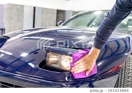 detailing and polishing the body of a luxury sports car using a micro fiber detailing and polishing the body of a luxury sports car using a micro fiber 101053664