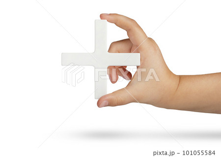 White plus symbol in hand. The concept of social security, and health insurance. Personal development, growth concept. Mathematical symbol plus of white color in a hand on a white isolated background 101055584